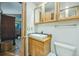 Cozy bathroom featuring a wood vanity, sink, and toilet at 12173 W 27Th Dr, Lakewood, CO 80215