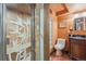 Bathroom with a tile shower, patterned glass, vanity and toilet at 12173 W 27Th Dr, Lakewood, CO 80215