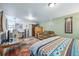 Bedroom with queen bed, work space and refrigerator at 12173 W 27Th Dr, Lakewood, CO 80215