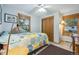 A well-lit bedroom with a closet, a desk, and hardwood floors at 12173 W 27Th Dr, Lakewood, CO 80215