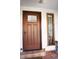 Inviting front entry featuring a solid wood door with a decorative glass insert and brick steps at 12173 W 27Th Dr, Lakewood, CO 80215