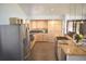 Modern kitchen featuring stainless steel appliances, light cabinets, and a center island with cooktop at 12173 W 27Th Dr, Lakewood, CO 80215