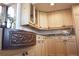 Close-up of kitchen sink with decorative copper sink and light wood cabinetry at 12173 W 27Th Dr, Lakewood, CO 80215
