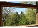 Scenic view from the window showcasing lush greenery and distant hills under a blue sky at 12173 W 27Th Dr, Lakewood, CO 80215