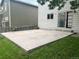 Concrete back patio with sliding glass door access to the home and grassy surroundings at 21767 Silver Meadow Ln, Parker, CO 80138