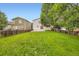 This backyard features a lush lawn and a patio at 21767 Silver Meadow Ln, Parker, CO 80138
