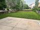 Large, grassy backyard enclosed by a wooden fence with a concrete patio at 21767 Silver Meadow Ln, Parker, CO 80138