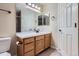 Well-lit bathroom displaying a vanity with a sink and a toilet, with neutral walls at 21767 Silver Meadow Ln, Parker, CO 80138