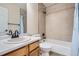 Bright bathroom features a tub with a tiled shower, and a vanity with a white countertop and wood cabinets at 21767 Silver Meadow Ln, Parker, CO 80138