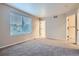Well-lit bedroom features carpet, a large window with blinds, and a closet at 21767 Silver Meadow Ln, Parker, CO 80138
