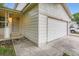 Corner view of a two-story home with attached garage and covered front entrance at 21767 Silver Meadow Ln, Parker, CO 80138