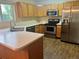Functional kitchen with stainless steel appliances, wood cabinets, and a laminate countertop at 21767 Silver Meadow Ln, Parker, CO 80138