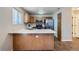 Well-lit kitchen featuring stainless steel appliances, ample counter space, and natural wood cabinets at 21767 Silver Meadow Ln, Parker, CO 80138