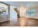 Spacious living room with hardwood floors, lots of natural light, and open floor plan to the kitchen at 21767 Silver Meadow Ln, Parker, CO 80138