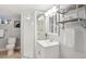 Bathroom featuring glass enclosed shower, single sink vanity and chrome fixtures at 2683 Bellaire St, Denver, CO 80207