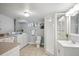Bathroom featuring glass enclosed shower, single sink vanity, washer and dryer at 2683 Bellaire St, Denver, CO 80207