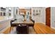 View of dining area with wood floors, leading into kitchen with stainless steel appliances at 2683 Bellaire St, Denver, CO 80207