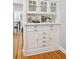 Dining room featuring custom built-in cabinets and hardwood floors at 2683 Bellaire St, Denver, CO 80207