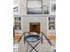 Close-up of decorative fireplace with white tile surround and built-in shelving at 2683 Bellaire St, Denver, CO 80207