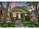 Charming brick home with landscaped yard and inviting front porch, surrounded by mature trees at 2683 Bellaire St, Denver, CO 80207