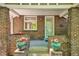 Inviting brick front porch with decorative potted plants and classic architectural details at 2683 Bellaire St, Denver, CO 80207