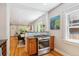 Kitchen with stainless steel stove, hardwood floors, and open to living area at 2683 Bellaire St, Denver, CO 80207