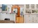 Kitchen and dining area with hardwood floors and stainless steel appliances at 2683 Bellaire St, Denver, CO 80207