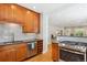 Kitchen with stainless steel appliances, tile backsplash and hardwood floors at 2683 Bellaire St, Denver, CO 80207