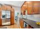 Bright kitchen features stainless steel appliances, wood cabinets and hardwood floors at 2683 Bellaire St, Denver, CO 80207