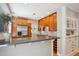 Well lit, stainless steel kitchen with granite counters and wood cabinets at 2683 Bellaire St, Denver, CO 80207