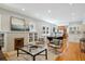 Open-concept living area with fireplace, seamlessly connecting to the dining space and kitchen at 2683 Bellaire St, Denver, CO 80207