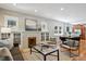 Spacious living room flows into dining area featuring beautiful hardwood floors and natural light at 2683 Bellaire St, Denver, CO 80207