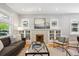 Bright living room with decorative fireplace and built-in shelving, perfect for relaxing or entertaining at 2683 Bellaire St, Denver, CO 80207
