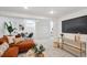 Spacious living room featuring modern decor, plush seating, and a view of the dining area at 2683 Bellaire St, Denver, CO 80207