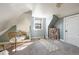 Bright finished attic includes a window, slanted ceilings, seating, and a gray and beige yoga mat at 3147 Umatilla St, Denver, CO 80211