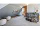 Unique attic space featuring a brick column, cozy design elements, and a spiral staircase at 3147 Umatilla St, Denver, CO 80211