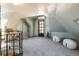 Spacious finished attic features neutral carpet, slanted ceilings, a door to the exterior, and two large poufs at 3147 Umatilla St, Denver, CO 80211