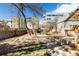 View of the backyard with brick pavers, grass, trees, and wooden fence at 3147 Umatilla St, Denver, CO 80211