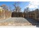 Gravel area in backyard is surrounded by a wooden fence with a small gate and access point at 3147 Umatilla St, Denver, CO 80211