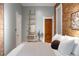 Bedroom featuring exposed brick wall, blue walls and accents, and ladder at 3147 Umatilla St, Denver, CO 80211
