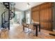 Dining room showcasing a unique spiral staircase, decorative sliding wood doors, and an open floor plan at 3147 Umatilla St, Denver, CO 80211