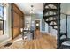 Dining room featuring wood floors, with decorative sliding wood doors and a unique spiral staircase at 3147 Umatilla St, Denver, CO 80211