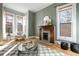 Living room with wood floors, featuring a fireplace, natural light, and a neutral color scheme at 3147 Umatilla St, Denver, CO 80211