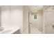 Contemporary bathroom featuring a sleek vanity, a spacious shower with marble-like tiles, and recessed lighting at 22341 E 38Th Pl, Aurora, CO 80019