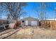 Backyard features a one-car garage, dog house and garden area at 2921 N Fillmore St, Denver, CO 80205