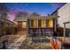 Charming brick bungalow with a cozy sunroom and well-tended garden beds in the front yard at 2921 N Fillmore St, Denver, CO 80205