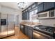 Well-appointed kitchen with stainless steel appliances, dark cabinetry, and hardwood floors at 2921 N Fillmore St, Denver, CO 80205