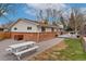 Spacious backyard with a brick patio, grass and picnic table, perfect for outdoor enjoyment at 11542 W 67Th Way, Arvada, CO 80004
