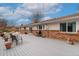 Charming backyard retreat featuring a patio, grill, and comfortable seating arrangement with overhead string lights at 11542 W 67Th Way, Arvada, CO 80004