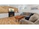 Finished basement features a cozy fireplace, wood wall paneling, and comfortable seating at 11542 W 67Th Way, Arvada, CO 80004